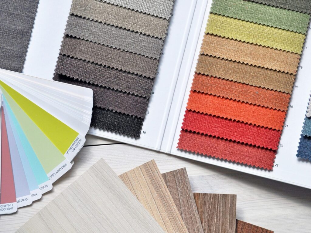 Colorful fabric and paint swatches laid out for design inspiration and material selection.